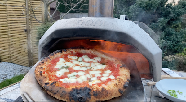 Neapolitan margherita pizza coming out of the Ooni Karu 12 pizza oven