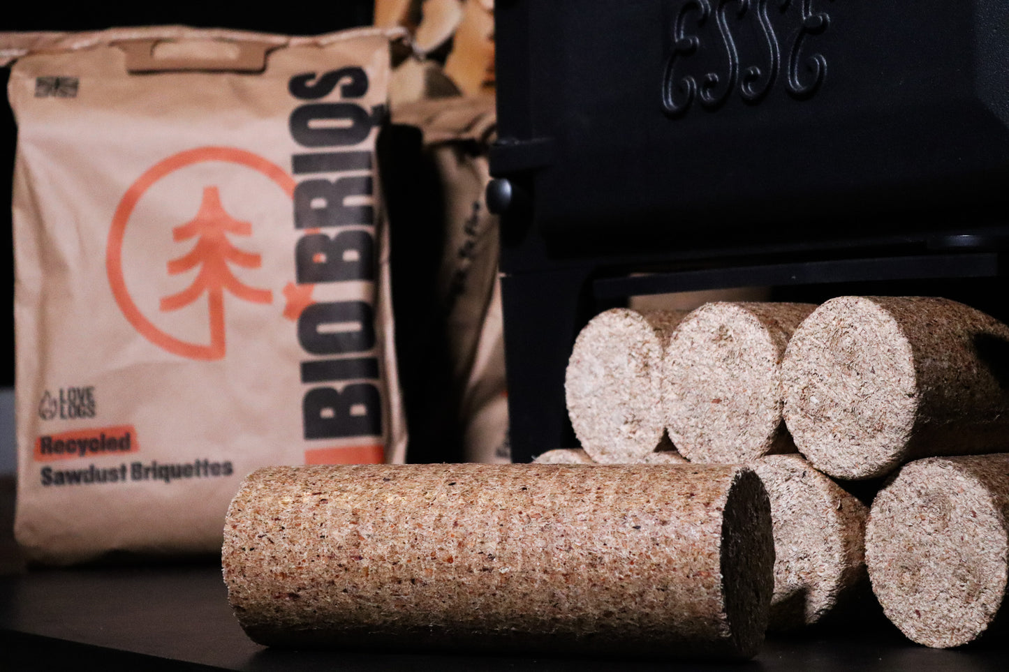 Bio Briqs firewood briquette unpacked in front of log burner and bag