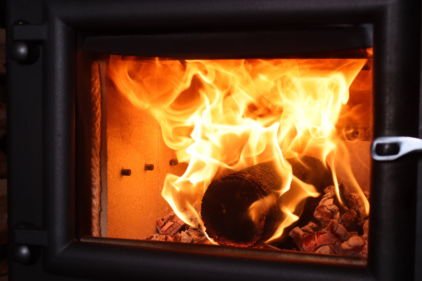 Bio Briqs firewood briquette fully on fire in a log burner
