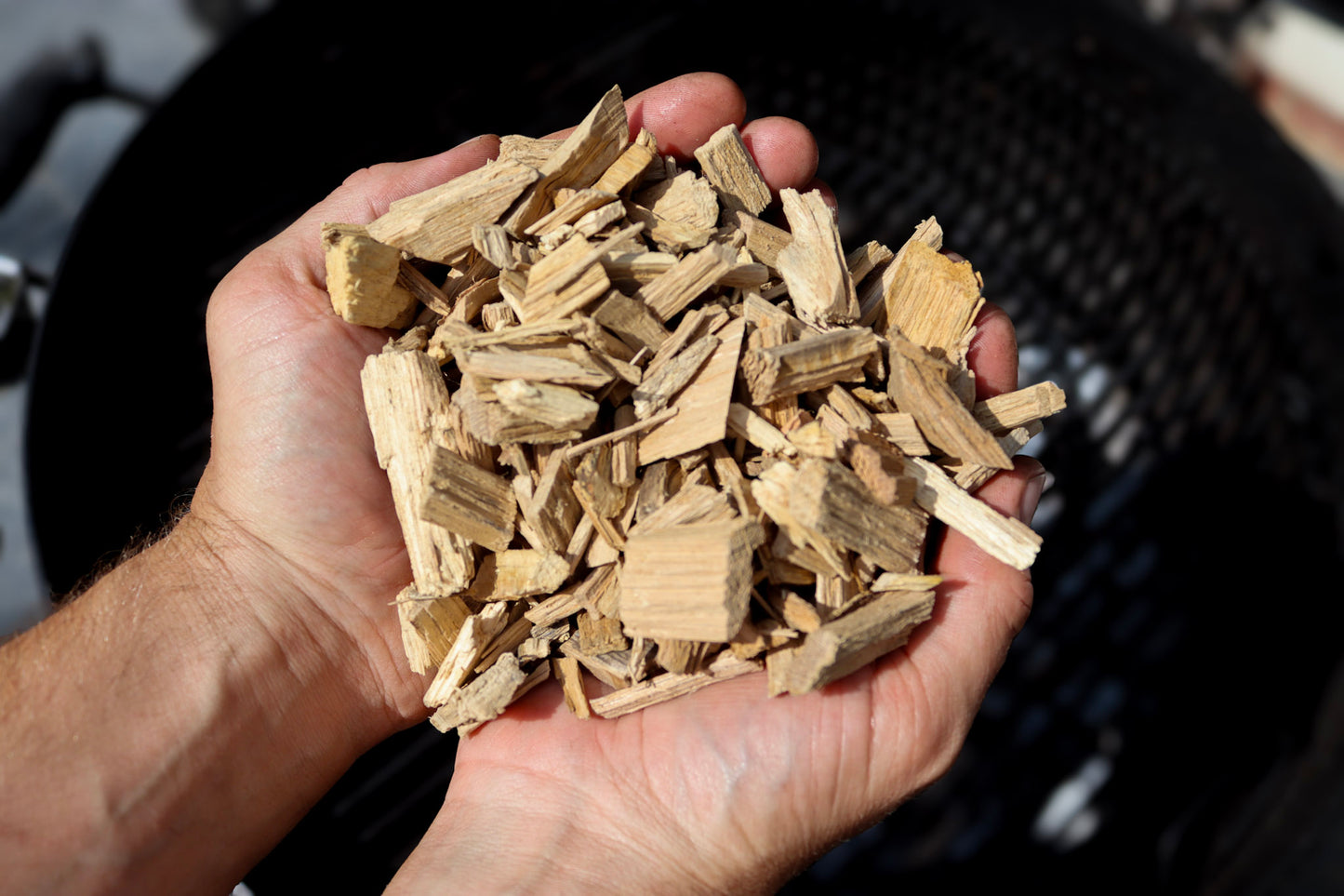 Love Logs British oak smoking chips held in cupped hands