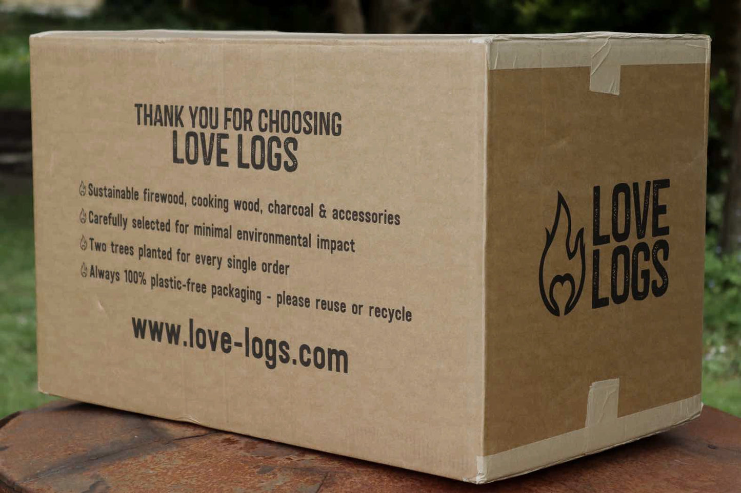 Love Logs Charcoal Shipping Box which reads 'Thank you for choosing Love Logs, sustainable firewood, cooking wood, charcoal and accessories carefully selected for minimal environmental impact.