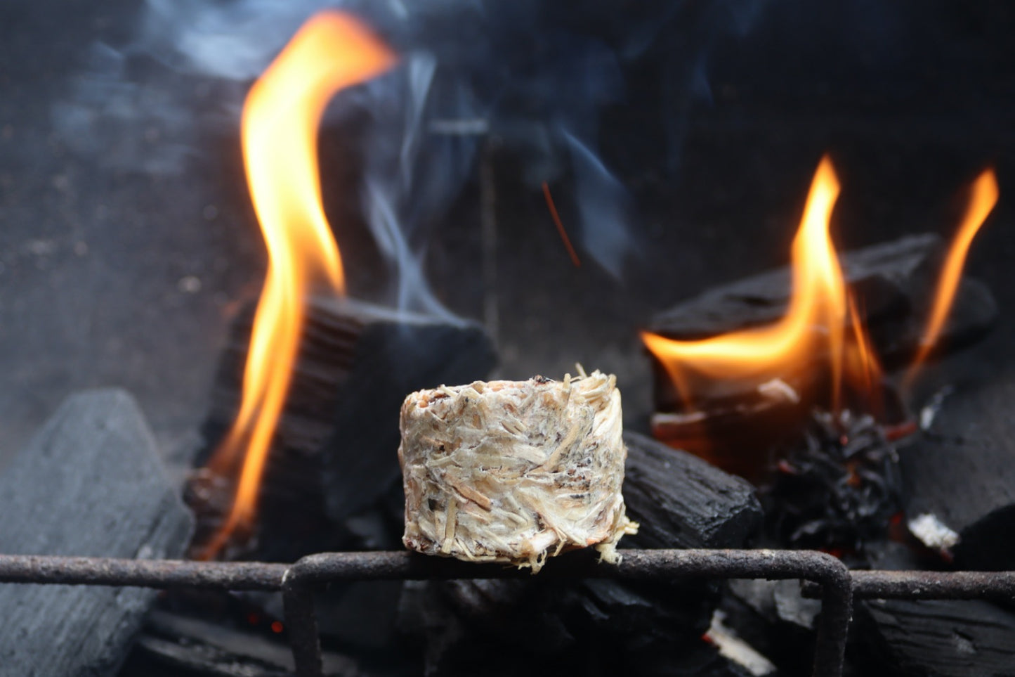 A natural firelighter next to burning charcoal