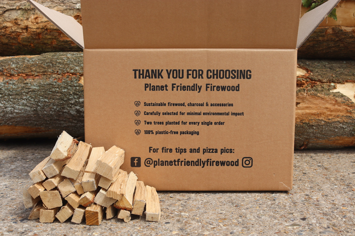 Oak hardwood kindling for pizza ovens shown boxed in plastic free packaging in front of timber