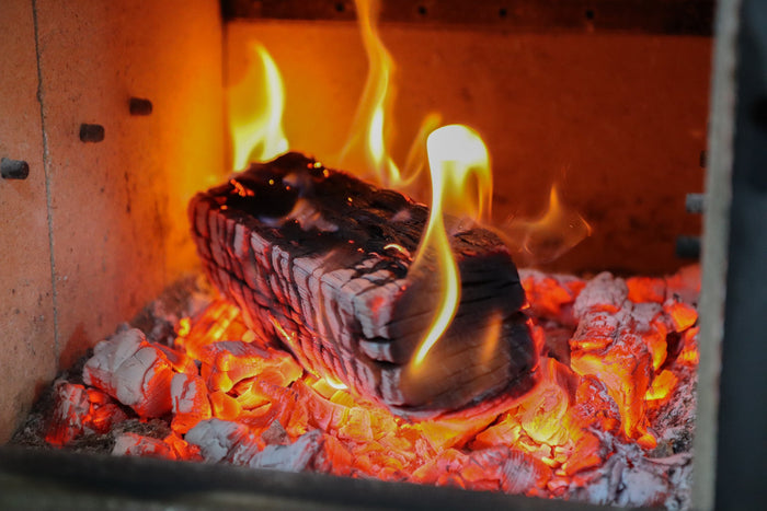 Oak log burning cleanly in a log burner