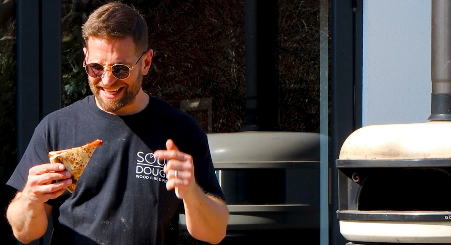 Paul from Love Logs eating pizza