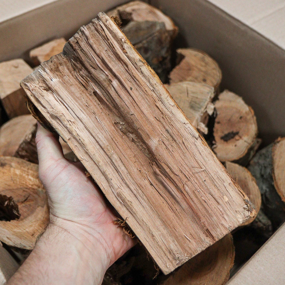 
                      
                        Love Logs apple wood logs in hand
                      
                    