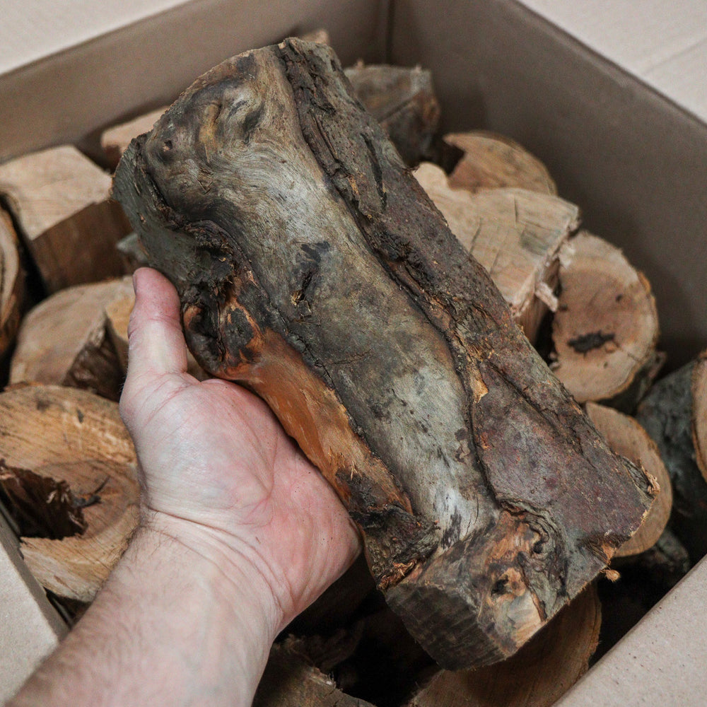 
                      
                        Love Logs apple wood logs in hand
                      
                    