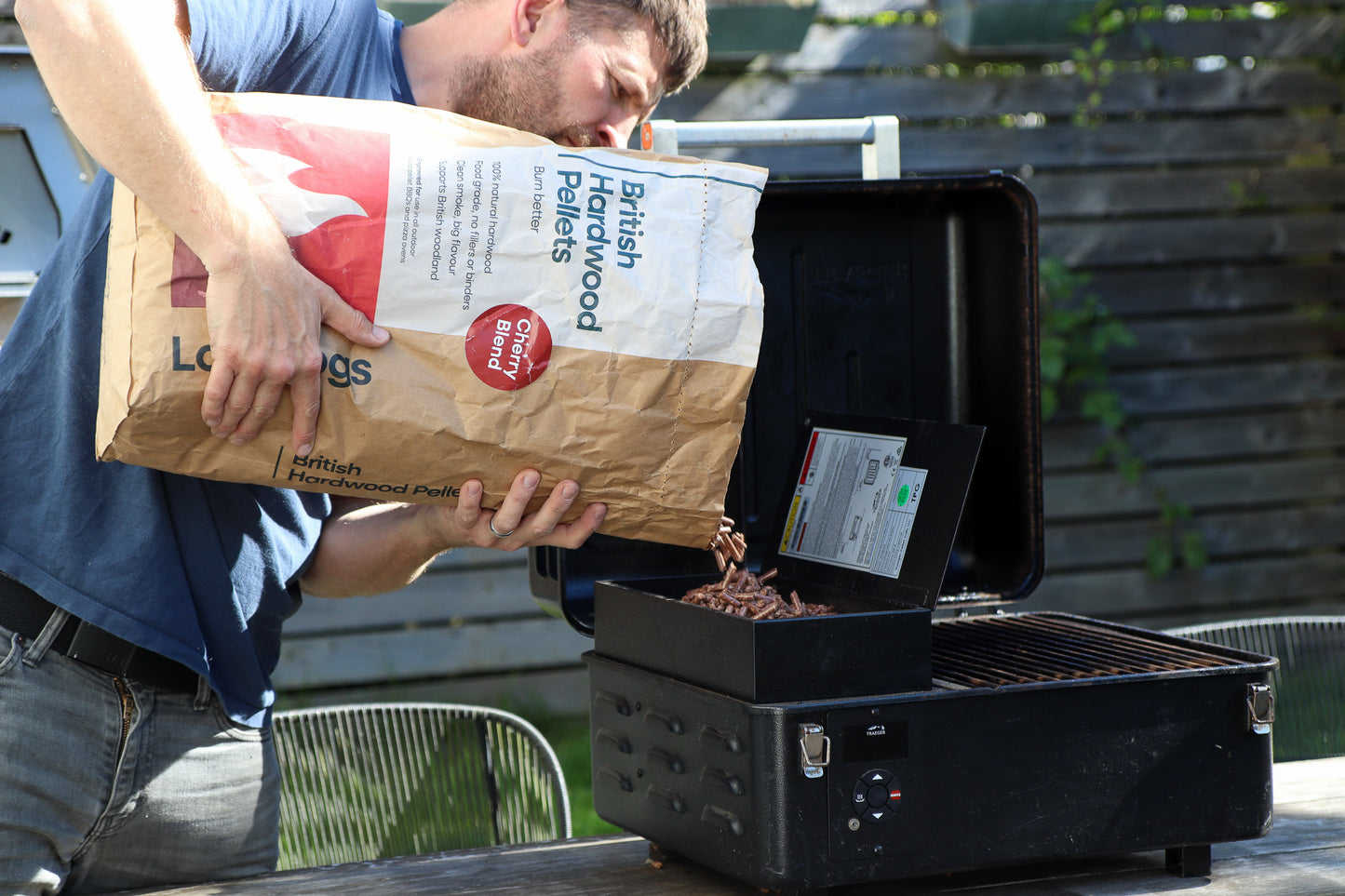 Paul Pouring British Hardwood Pellets Into Traeger Smoker