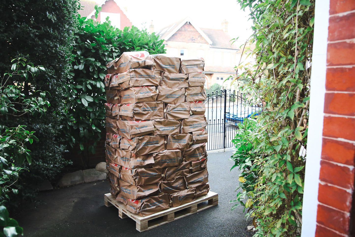 Pallet of Ready to Burn logs on a driveway